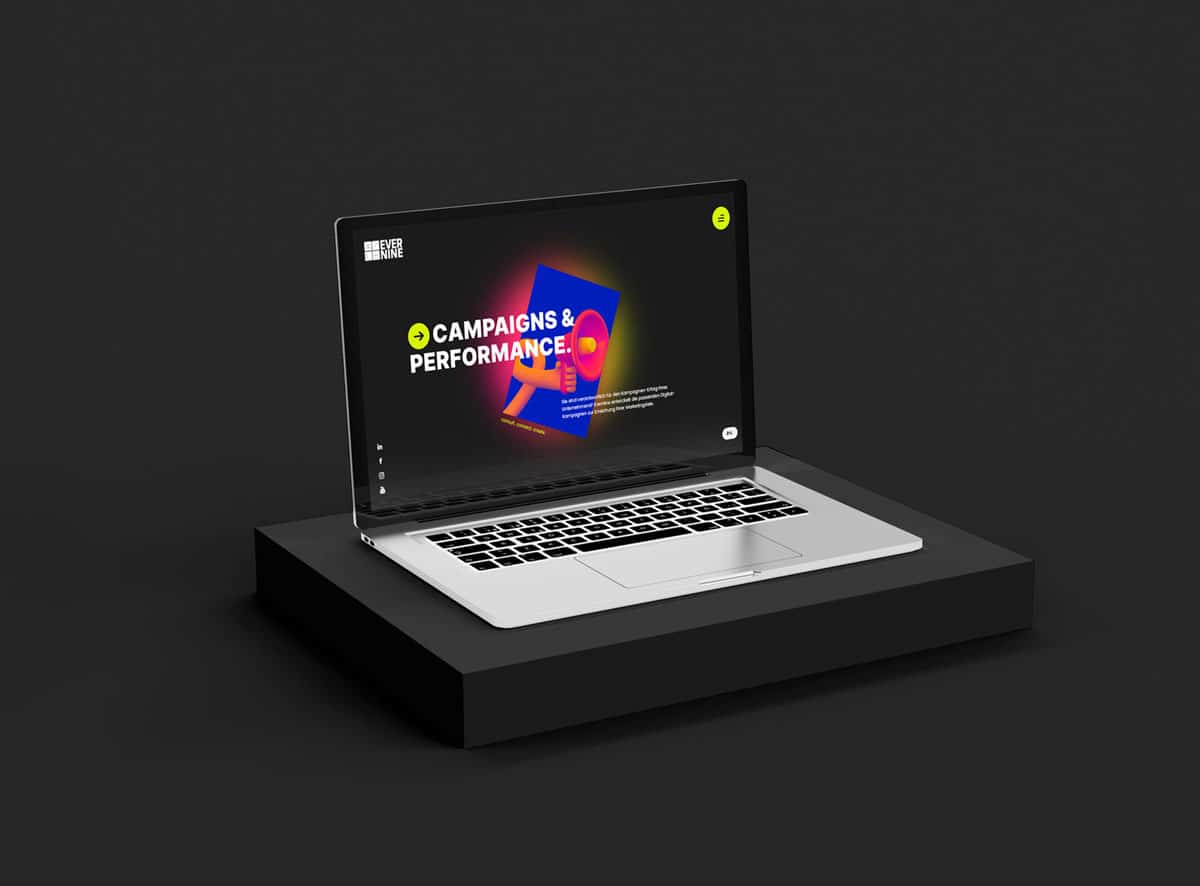 Ein silberner Laptop steht auf einer schwarzen Plattform vor einem dunklen Hintergrund und zeigt eine lebendige Unternehmenswebsite mit dem Text CAMPAIGNS & PERFORMANCE in weißer Schrift über bunten geometrischen Formen, die innovative Website-Entwicklung und Automatisierung hervorheben. - NINE brackets Digitalagentur München